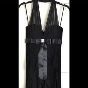 Elegant formal black dress with flowy ruffles silky accents weddings banquets